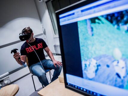 A user is interacting in the Virtual Environment with through head mounted device